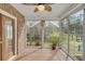 Enclosed sunroom featuring brick accents, neutral paint, and views of the backyard at 8615 Arthur Hills Cir, North Charleston, SC 29420