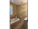 Bathroom featuring a soaking tub and vanity sink with wallpaper design at 1001 Jungle Shores Dr # 1/4 Share Interval, Edisto Beach, SC 29438