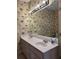 Bathroom with a double sink vanity and palm-patterned wallpaper at 1001 Jungle Shores Dr # 1/4 Share Interval, Edisto Beach, SC 29438