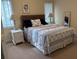 Charming bedroom showcasing matching nightstands, lamps, and a seashell patterned comforter at 1001 Jungle Shores Dr # 1/4 Share Interval, Edisto Beach, SC 29438