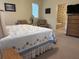 Bright bedroom with a large bed, comfy chairs, and an en-suite bathroom at 1001 Jungle Shores Dr # 1/4 Share Interval, Edisto Beach, SC 29438