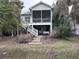 Charming coastal home with a screened porch, wooden stairs, and a swing underneath the house at 1001 Jungle Shores Dr # 1/4 Share Interval, Edisto Beach, SC 29438