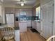 Traditional kitchen with tiled backsplash, white appliances, wood floors, and light wood cabinetry at 1001 Jungle Shores Dr # 1/4 Share Interval, Edisto Beach, SC 29438