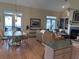 Spacious living room with wood floors, neutral paint, and large windows allowing for plenty of natural light at 1001 Jungle Shores Dr # 1/4 Share Interval, Edisto Beach, SC 29438