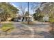 Charming single-story house with a gravel driveway and mature trees at 111 A Heatley St, Moncks Corner, SC 29461
