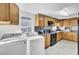 A fully equipped kitchen with wood cabinets, appliances, and a convenient washer and dryer at 111 A Heatley St, Moncks Corner, SC 29461