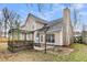 A charming backyard featuring a wooden pergola, patio, and lush landscaping at 113 Hartley Hall Ct, Summerville, SC 29485