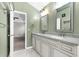 Bathroom with double sinks, marble countertops, and white cabinets with decorative door fronts at 113 Hartley Hall Ct, Summerville, SC 29485