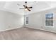 Spacious bedroom with a ceiling fan, carpeted floor, and two windows providing natural light at 113 Hartley Hall Ct, Summerville, SC 29485