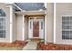 Welcoming entrance featuring a glass door and manicured landscaping, creating an inviting first impression at 113 Hartley Hall Ct, Summerville, SC 29485