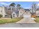 Inviting two-story home with a well-manicured lawn, attached garage, and classic architectural details at 113 Hartley Hall Ct, Summerville, SC 29485