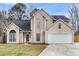 Charming two-story home featuring a two-car garage and manicured lawn at 113 Hartley Hall Ct, Summerville, SC 29485