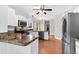 Stylish kitchen with stainless steel appliances, wood floors, and bright lighting at 113 Hartley Hall Ct, Summerville, SC 29485
