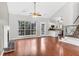 Open-concept living area with wood floors, fireplace, and views of the kitchen and staircase at 113 Hartley Hall Ct, Summerville, SC 29485