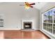 Bright living room featuring a brick fireplace, vaulted ceilings, wood floors, and large windows at 113 Hartley Hall Ct, Summerville, SC 29485