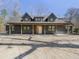 A modern farmhouse with a covered porch featuring wooden support beams at 1195 Michelle Ln, Johns Island, SC 29455