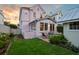 Charming pink home featuring a lush green backyard and brick patio, perfect for outdoor relaxation at 12 Percy St, Charleston, SC 29403