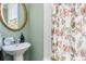 Cozy bathroom features a floral shower curtain and vintage-inspired mirror at 12 Percy St, Charleston, SC 29403