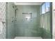 Modern shower showcasing the tile and design with a rainfall showerhead, and a window for natural light at 12 Percy St, Charleston, SC 29403