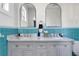 Elegant bathroom featuring a double vanity, arched mirrors, and turquoise tiling for a stylish and functional space at 12 Percy St, Charleston, SC 29403