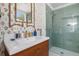 Chic bathroom featuring stylish tile in the shower, a wooden vanity, and floral wallpaper accents at 12 Percy St, Charleston, SC 29403