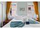 Bright bedroom with a king bed, soft yellow curtains, and two windows offering great natural light at 12 Percy St, Charleston, SC 29403