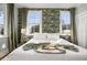 Charming bedroom with accent wallpaper and a luxurious bed with a tray of champagne and snacks at 12 Percy St, Charleston, SC 29403