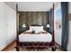 Bright bedroom with a canopy bed, vintage wallpaper, and storage wardrobe, offering a serene and stylish retreat at 12 Percy St, Charleston, SC 29403
