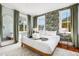 Bright bedroom with large bed, beautiful accent wallpaper, and two windows offering great natural light at 12 Percy St, Charleston, SC 29403
