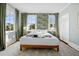 Stylish bedroom featuring a large bed, accent wallpaper, two windows, and white closet doors at 12 Percy St, Charleston, SC 29403