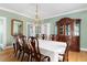 Elegant dining room features a long table with seating for ten and a charming chandelier at 12 Percy St, Charleston, SC 29403