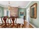 The dining room is filled with natural light and features brick accents at 12 Percy St, Charleston, SC 29403