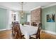 Traditional dining room with a decorative chandelier and a brick accent wall at 12 Percy St, Charleston, SC 29403
