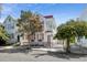 Charming two-story home featuring a wrought iron fence, second story porch, and a beautifully landscaped yard at 12 Percy St, Charleston, SC 29403