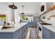 Modern kitchen featuring blue cabinets, a large island with counter seating, and stainless steel appliances at 12 Percy St, Charleston, SC 29403