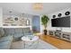 Open-concept living room with a stylish gray sectional, connecting to the kitchen area at 12 Percy St, Charleston, SC 29403