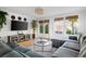 Bright living room with hardwood floors, stylish gray sectional, and lots of natural light at 12 Percy St, Charleston, SC 29403