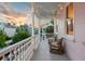 Charming porch with string lights, comfortable wicker furniture, and serene neighborhood views for relaxing outdoors at 12 Percy St, Charleston, SC 29403