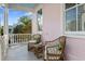 Cozy porch with wicker seating, scenic neighborhood views, and a painted ceiling for relaxed outdoor living at 12 Percy St, Charleston, SC 29403