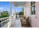 Charming porch with wicker seating, serene neighborhood views, and a painted ceiling for a relaxing outdoor space at 12 Percy St, Charleston, SC 29403