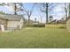 Expansive backyard featuring a well-maintained lawn, wooden fence, and mature trees at 1205 Scotch Pine Ln, Ladson, SC 29456