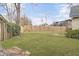 Large backyard with a well-maintained lawn, wooden fence, and mature landscaping at 1205 Scotch Pine Ln, Ladson, SC 29456