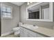 Bright bathroom with a large mirror, a sink with storage, and a window at 1205 Scotch Pine Ln, Ladson, SC 29456