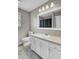 Bright bathroom with a large mirror, a sink with storage, and a window at 1205 Scotch Pine Ln, Ladson, SC 29456