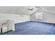 Large bonus room featuring blue carpeting, natural light, and a ceiling fan at 1205 Scotch Pine Ln, Ladson, SC 29456