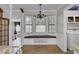 Charming breakfast nook features a window seat, chandelier, and view to the laundry and exercise rooms at 1205 Scotch Pine Ln, Ladson, SC 29456