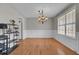 Bright dining room with a chandelier, hardwood floors, wainscoting, and a large window at 1205 Scotch Pine Ln, Ladson, SC 29456