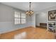 Dining room with natural light, hardwood floors, wainscoting, and modern decor at 1205 Scotch Pine Ln, Ladson, SC 29456