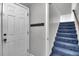 Entryway with white door, coat hooks, and a staircase leading to the upper level at 1205 Scotch Pine Ln, Ladson, SC 29456