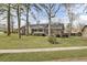 Charming brick home with a well-manicured front lawn and mature trees in a serene setting at 1205 Scotch Pine Ln, Ladson, SC 29456